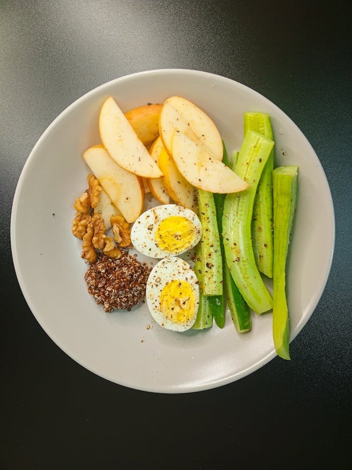 A nutritious and balanced breakfast bowl featuring eggs, fruits, and vegetables.
